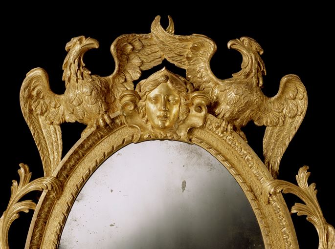 A GEORGE II CARVED GILTWOOD OVAL MIRROR | MasterArt
